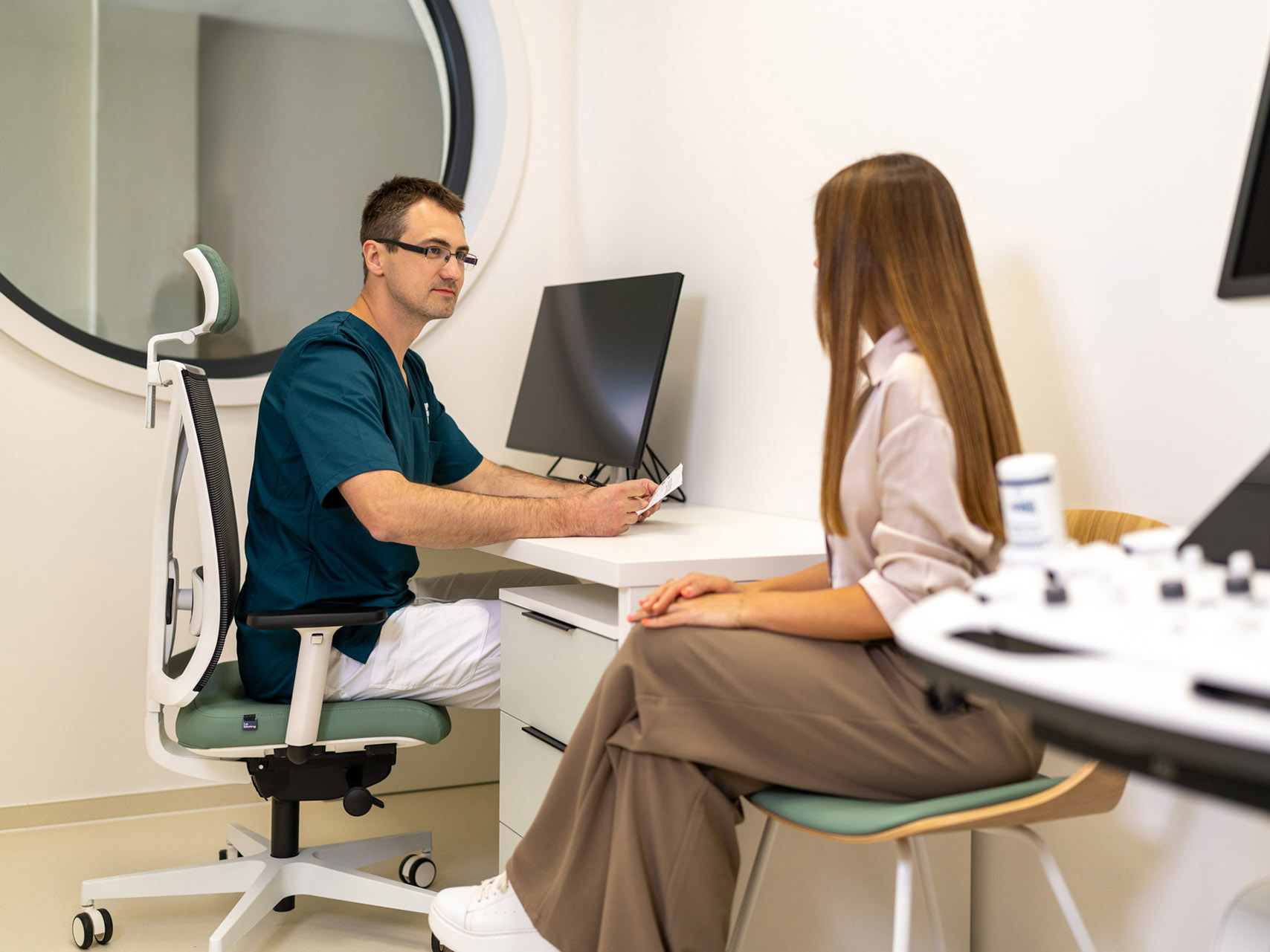 A consultant in conversation with a patient